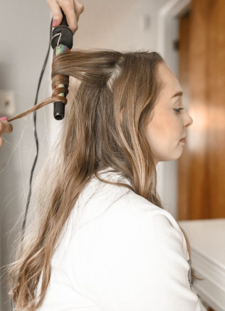 woman inside a hair salon getting her hair curl